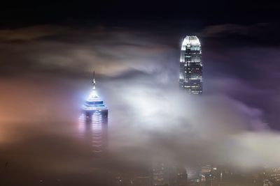 Low angle view of illuminated tower against sky at night