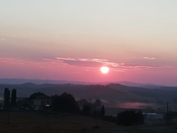 Scenic view of silhouette landscape against romantic sky at sunset