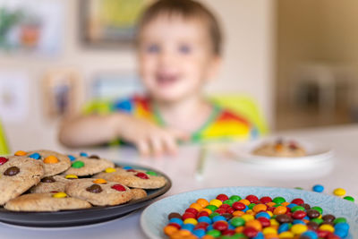 Portrait of smiling boy with food on table