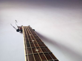 Close-up of guitar against white background