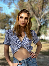 Portrait of young woman standing outdoors