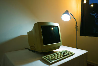 Close-up of electric lamp on table at home