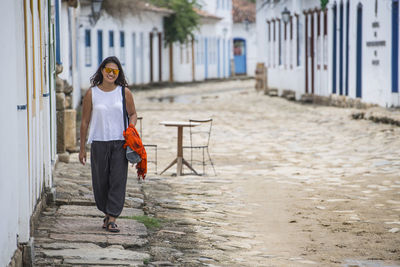 Woman walking through the streets of paraty in brazil