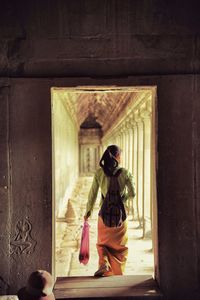 Full length of woman standing by railing