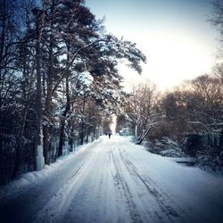 Road passing through snow covered landscape