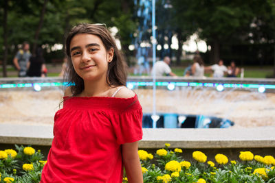 Portrait of a smiling young woman standing outdoors