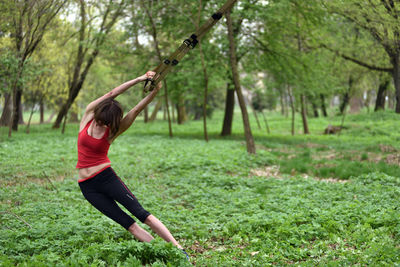 Mid adult woman exercising at park