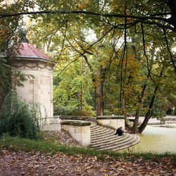 Woman sitting in park during autumn