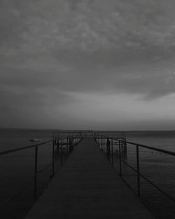 Pier over sea against sky