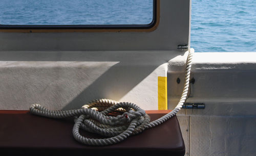 Close-up of rope tied on boat sailing in sea