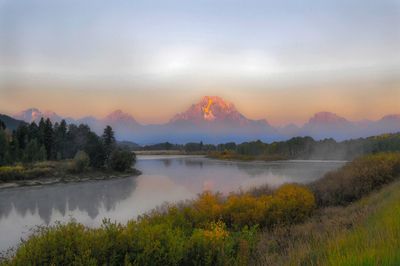 Scenic view of lake against sky during sunset