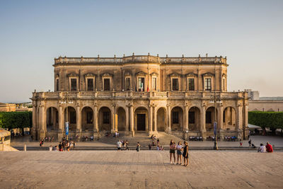 Group of people in front of historical building