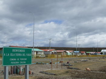 Road sign against sky