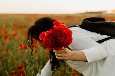 Midsection of woman holding bouquet