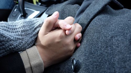 Close-up of man holding hands