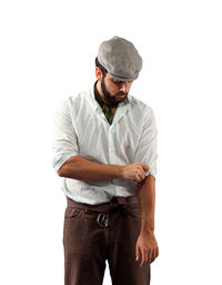 Young man looking away against white background