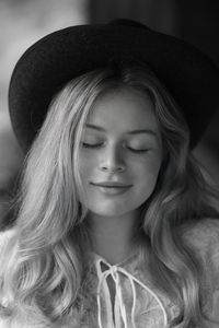 Close-up of young woman wearing hat