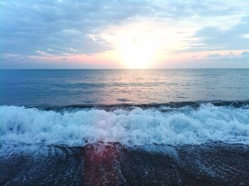 Scenic view of sea against cloudy sky