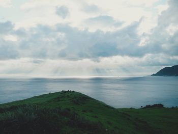 Scenic view of sea against cloudy sky