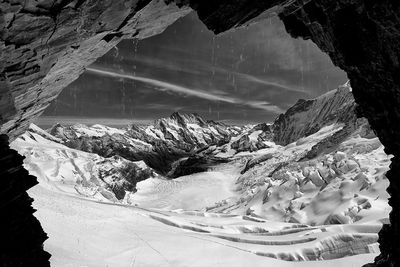 Scenic view of snow covered mountains against sky