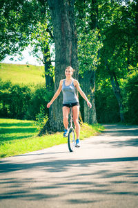 Full length portrait of man skateboarding on road