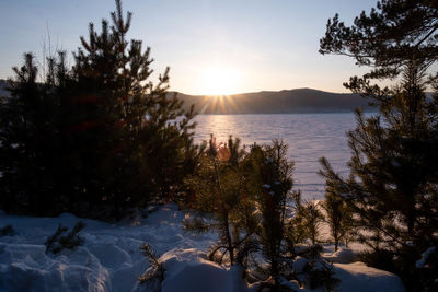Scenic view of snow covered mountains against sky during sunset