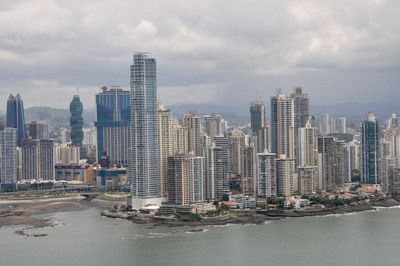 Cityscape against cloudy sky