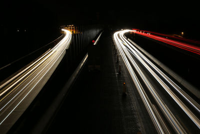 High angle view of light trails on road in city at night