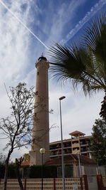 Low angle view of building against cloudy sky