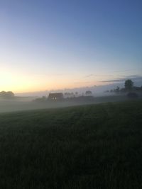 Scenic view of field against sky during sunset