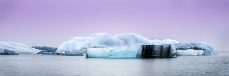 Ice floating on sea against sky