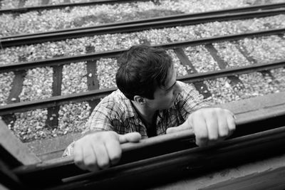 High angle view of man standing on railroad tracks