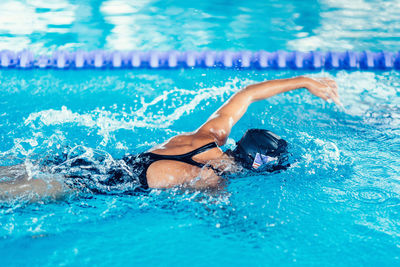 Woman swimming in pool during competition