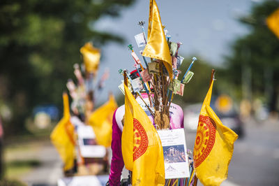 Close-up of yellow flags hanging against blurred background