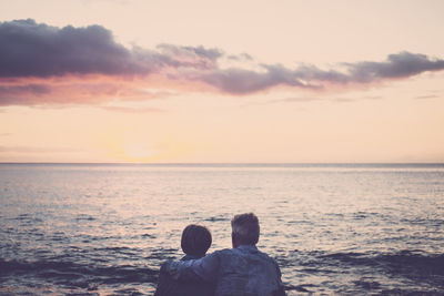 Senior couple by sea during sunset