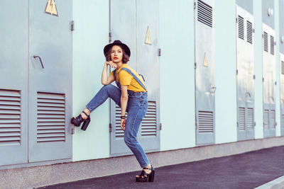 Woman standing against wall