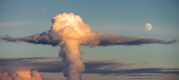 Low angle view of smoke emitting from chimney against sky