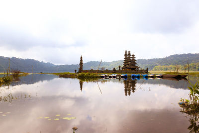 Panoramic view of lake by buildings against sky