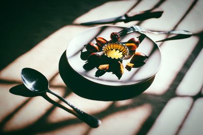 Palm oil and fruits in plate on table