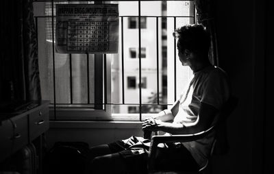 Side view of man sitting in bus