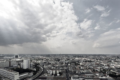 Cityscape against cloudy sky