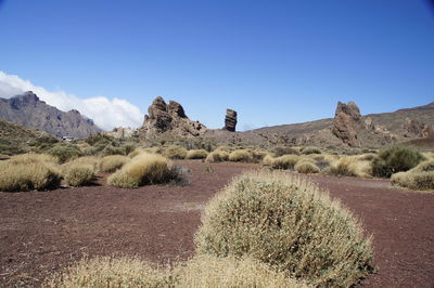 Scenic view of land against clear blue sky