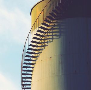 Low angle view of steps on silo against sky