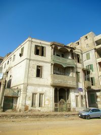 Old building in city against clear blue sky