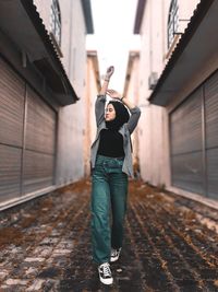 Full length of young girl standing in city