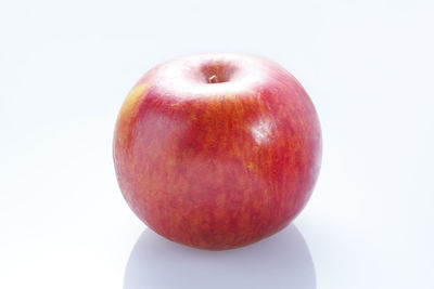 Close-up of red apple over white background