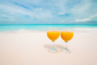 View of drink on beach against sky