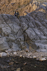 High angle view of man climbing on rock