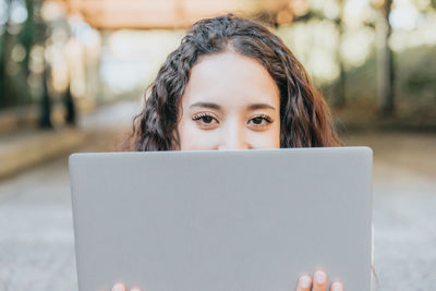 Young woman using laptop at table