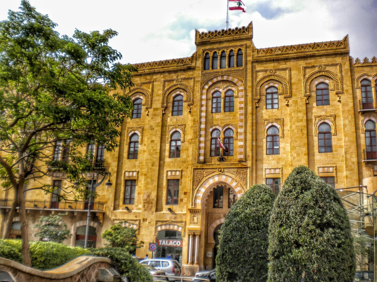 architecture, built structure, building exterior, tree, arch, low angle view, sky, window, facade, building, history, city, day, outdoors, growth, incidental people, no people, travel destinations, residential building, plant